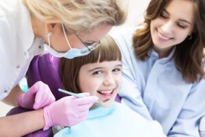 Little girl smiling with dentist