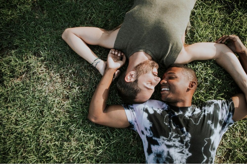 Gay couple relaxing in the grass