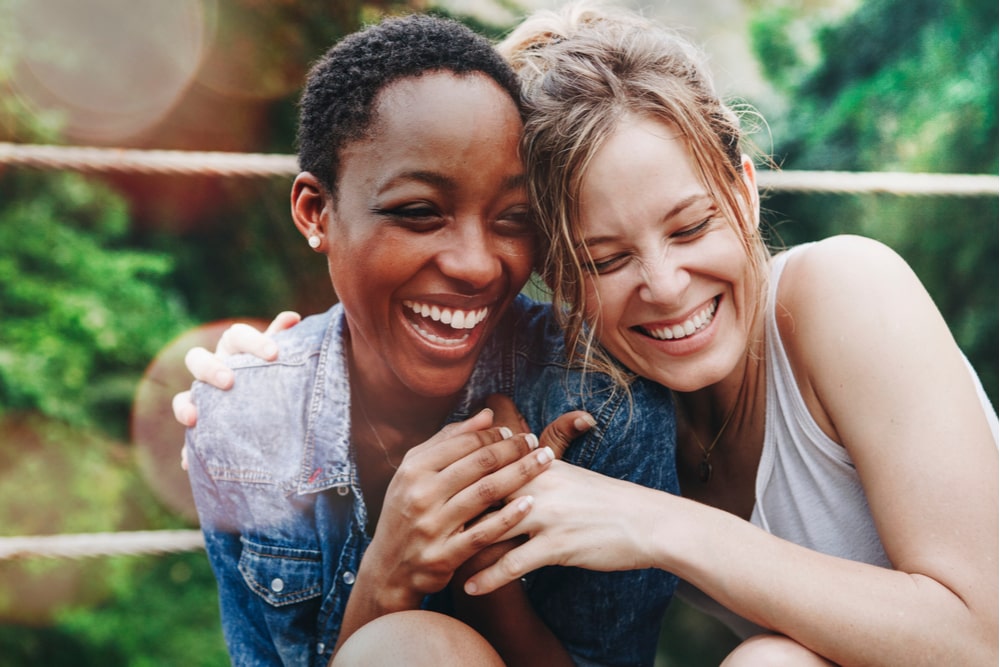 Cheerful girls embracing each other