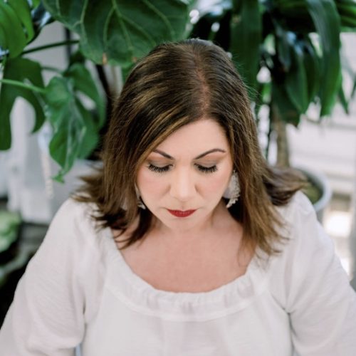 Aileen Nealie in white dress meditating