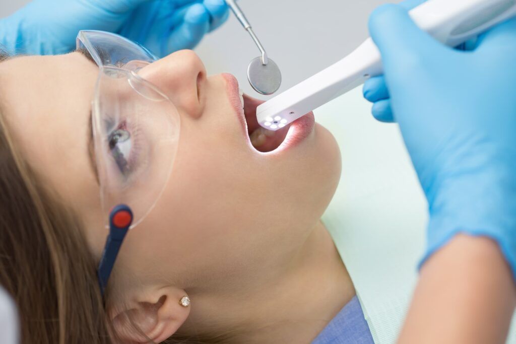 closeup of an intraoral scan being performed on a woman's mouth