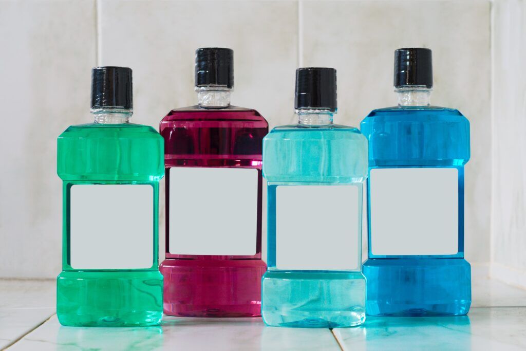 four different variations of mouthwash bottles