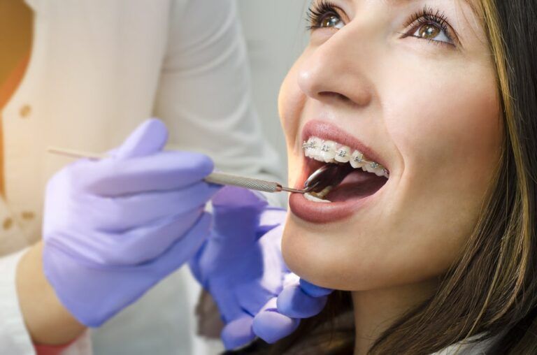 woman with braces having a dental exam