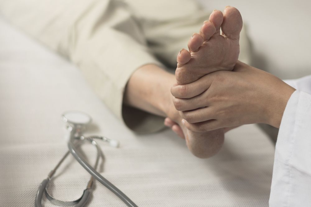 Heel Pain or plantar fasciitis concept. Doctor checking patient foot