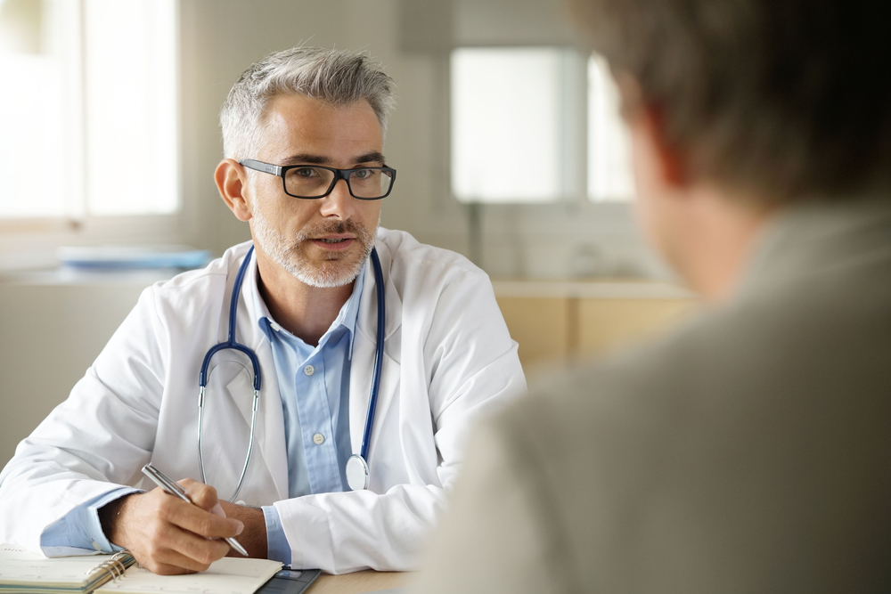 Doctor talking to patient in office