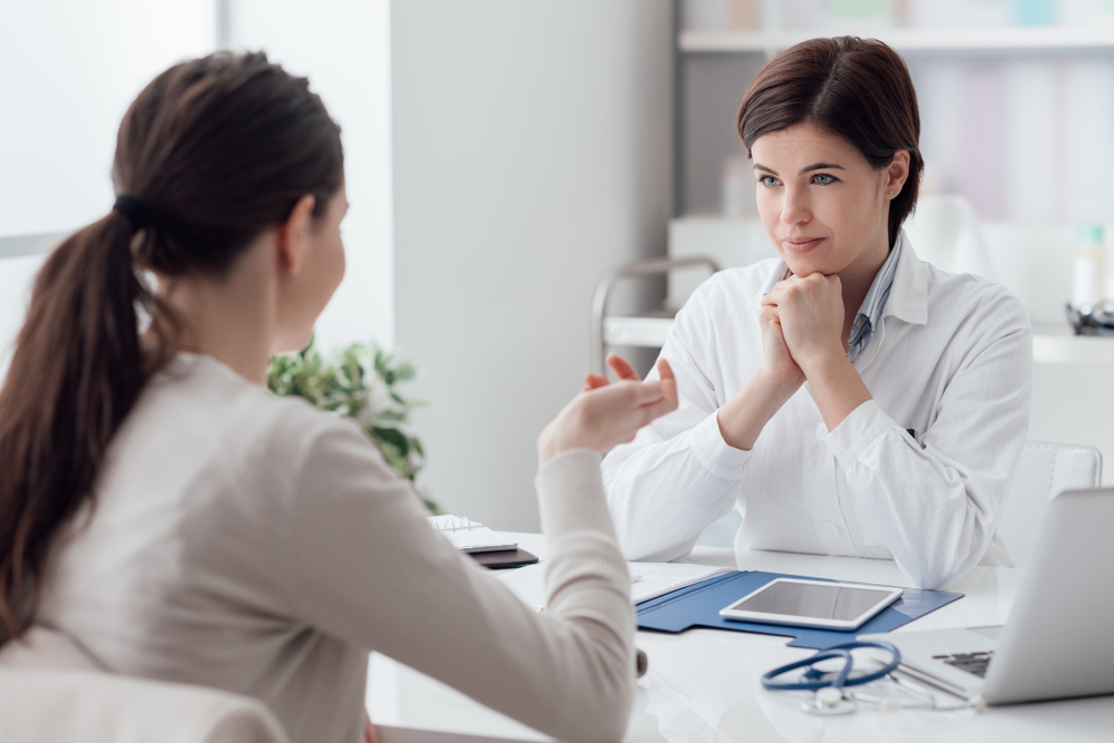 Doctor working in the office and listening to the patient