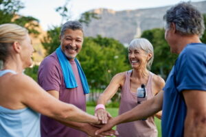 Group of happy seniors cheering together after fitness workout