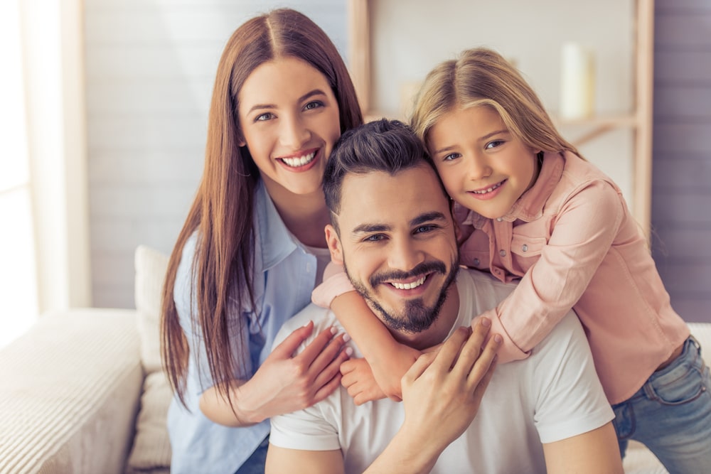 beautiful young mother, father and their daughter