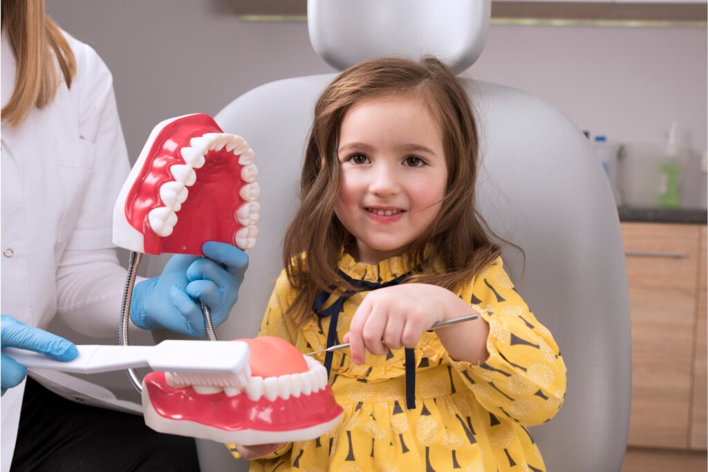 Little patient at dentist smiling and looking at camera