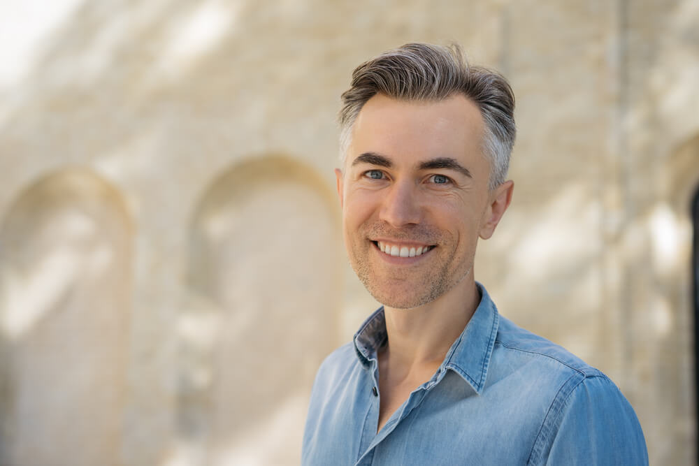 Closeup portrait of handsome middle aged man with stylish hairstyle wearing casual shirt