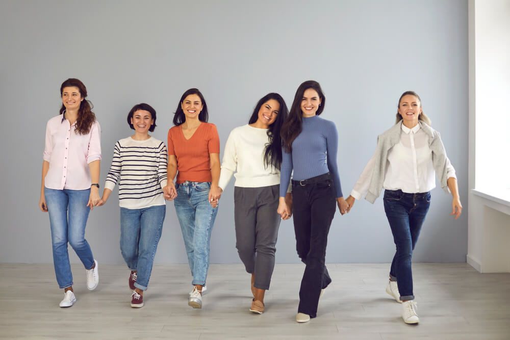 Group of happy confident young women in their 20s and 30s smiling