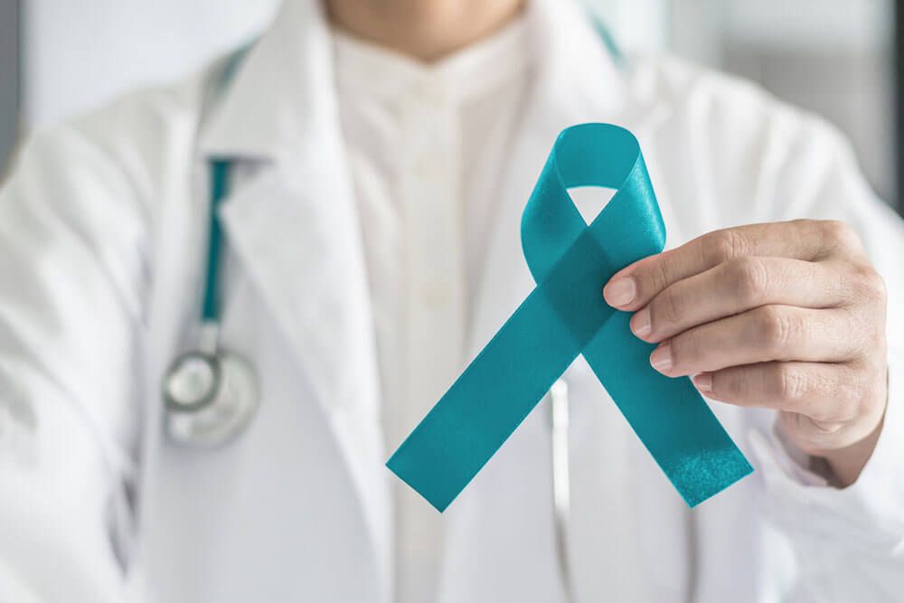Teal awareness ribbon in doctor's hand