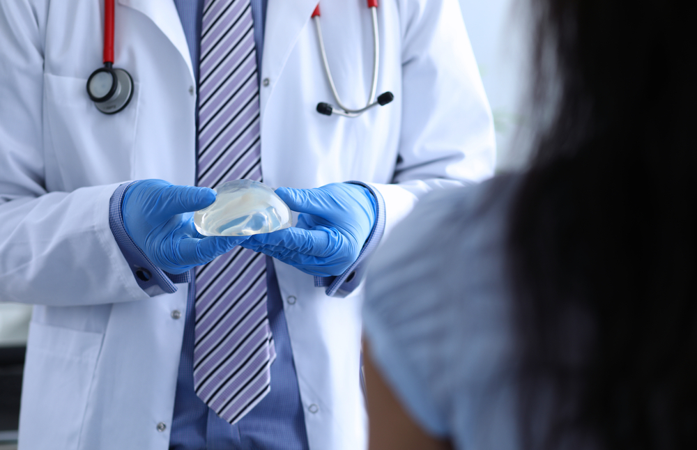 Surgeon doctor explains to girl features implant