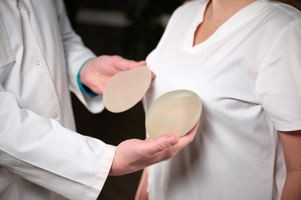The plastic surgeon holds breast silicone implants. Breast augmentation concept