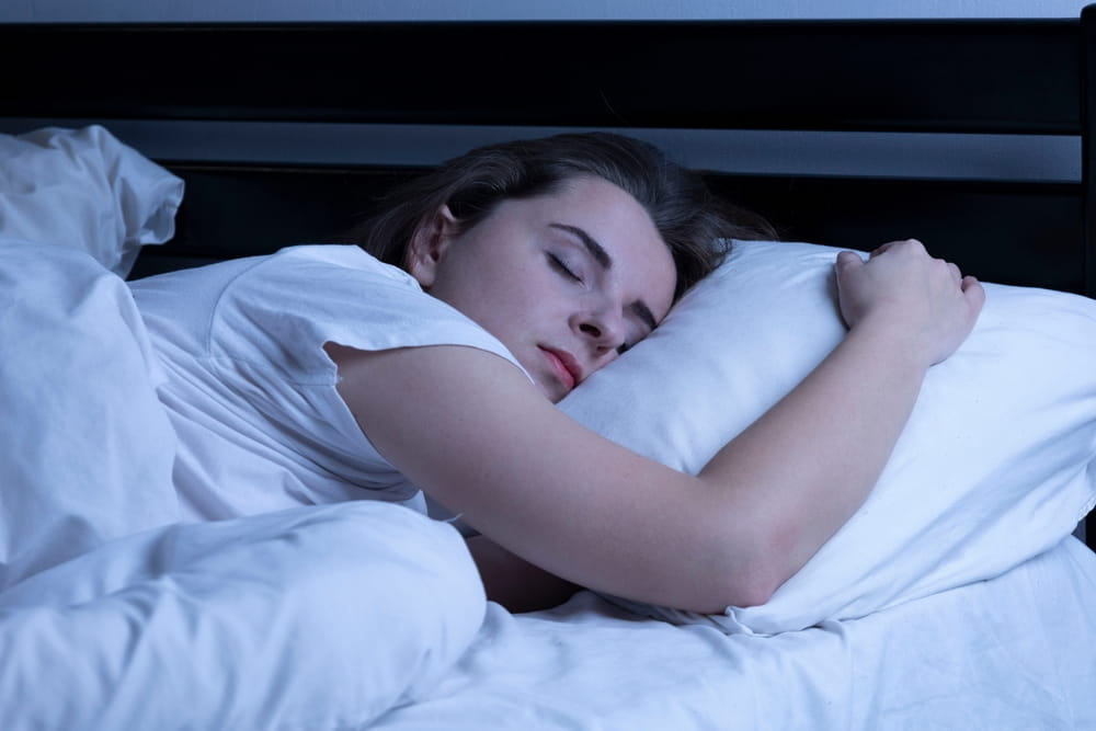 Woman sleeping soundly in bed at night