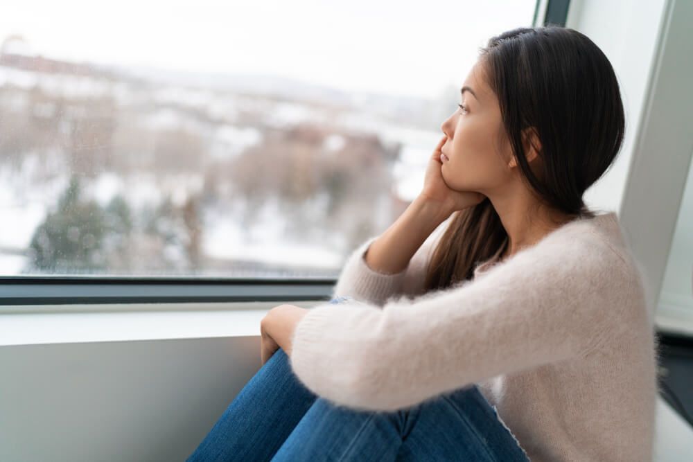 Winter seasonal affective disorder SAD depression mood alone Asian girl feeling lonely