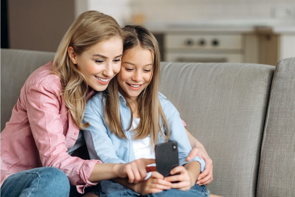 Smiling happy blonde mom and daughter