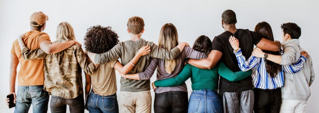 diverse people hugging each other