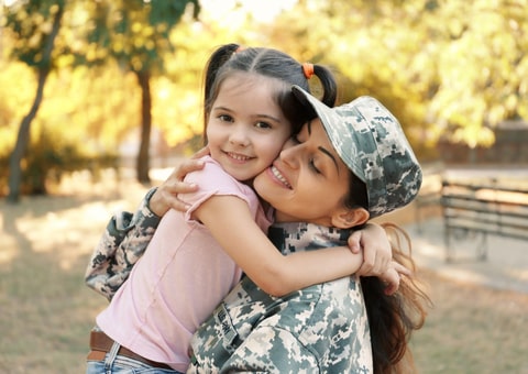 Woman in army uniform and her daughter