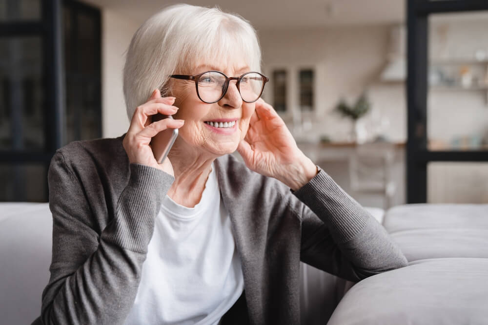 Happy smiling caucasian old senior elderly woman lady grandmother talking communicating with friends