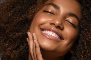 Beautiful african american woman face close up teeth smile happy positive