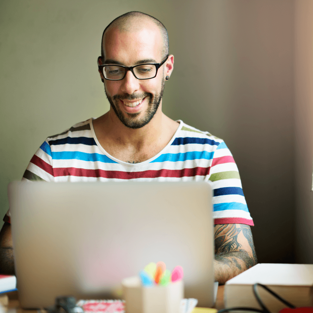 Smiling man using laptop