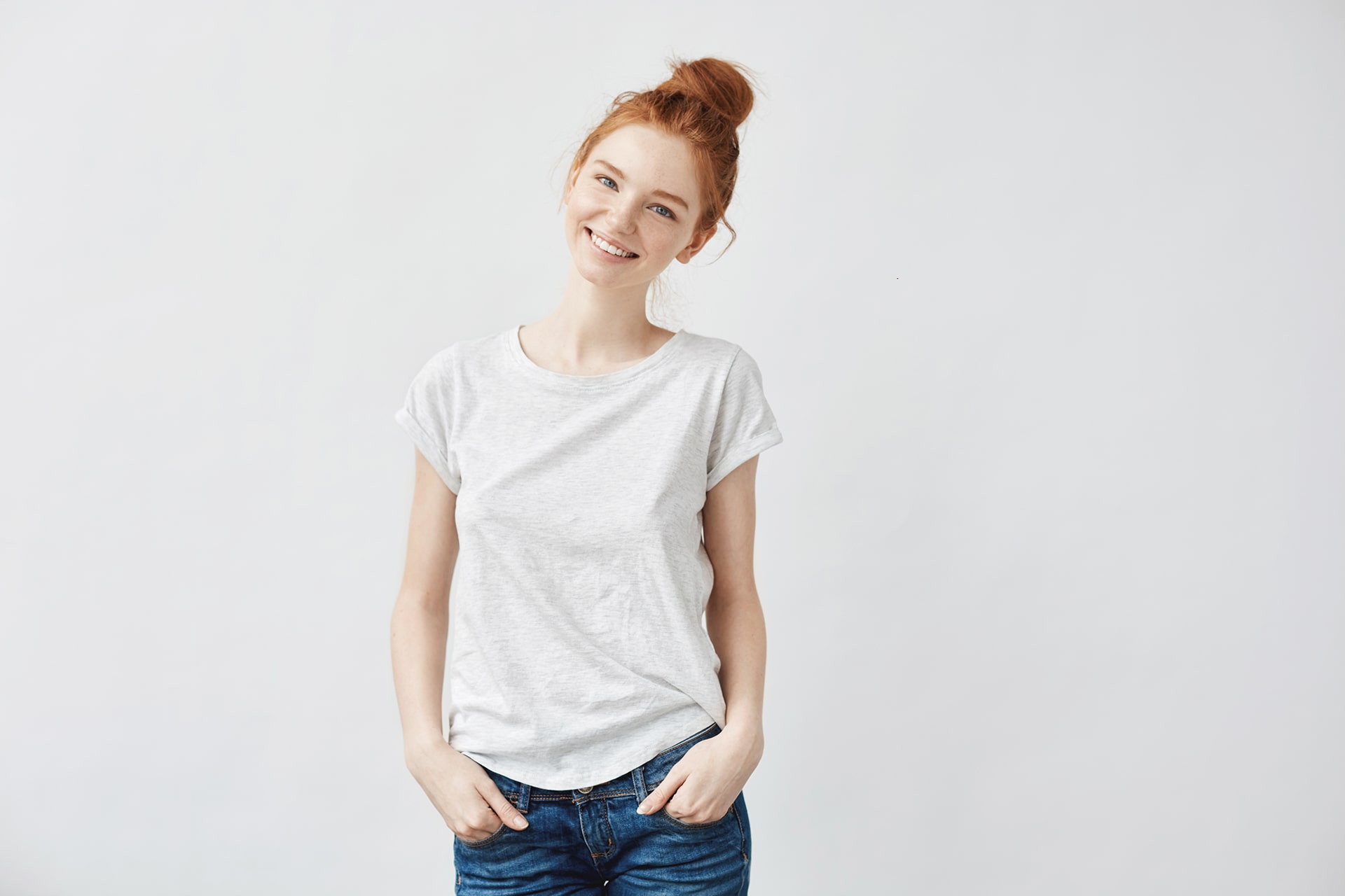 Redhead girl standing with hands in pockets