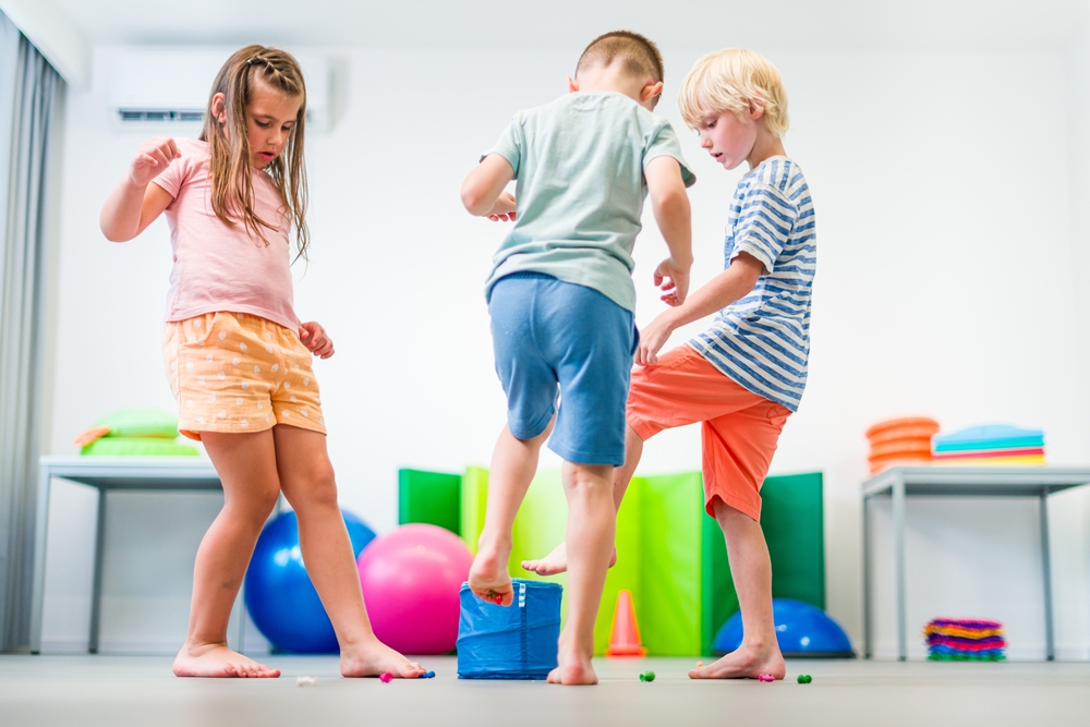 Young children exercising during group therapy session