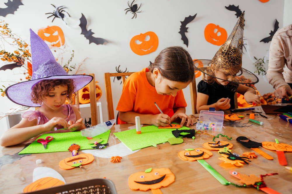 Happy children during Halloween art lesson at home