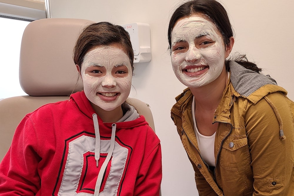 Teen girls smiling during facial