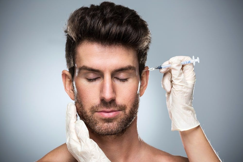 Man during surgery filling facial wrinkles