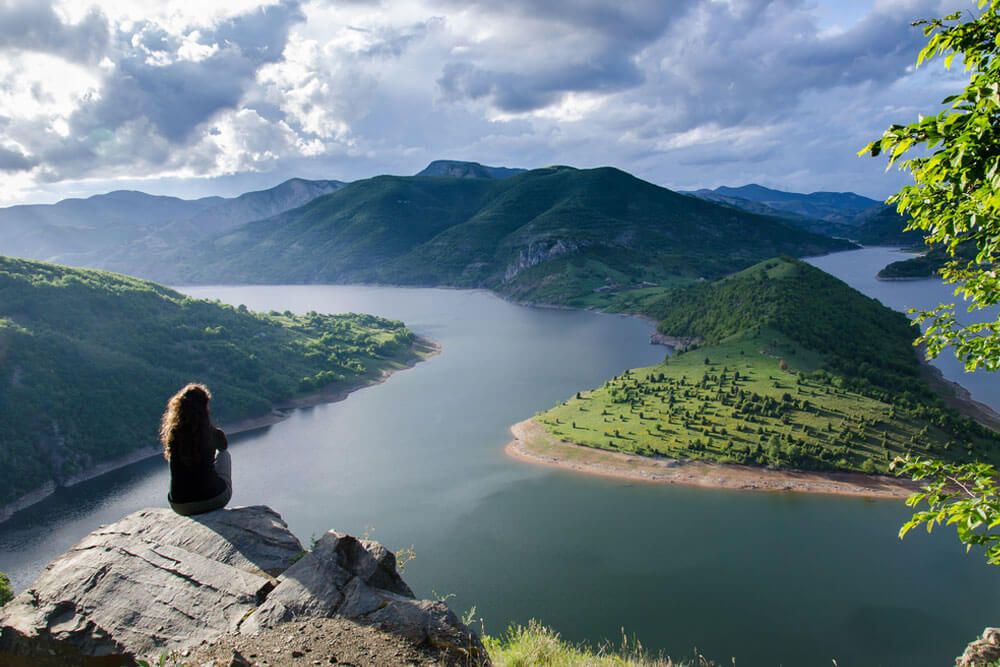 woman meditating relaxing alone Travel healthy Lifestyle concept lake and mountains