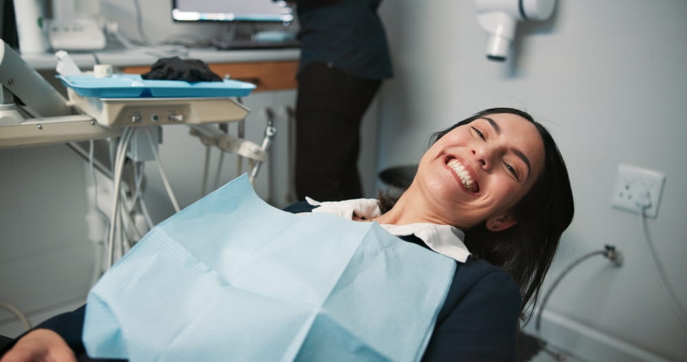 Happy woman, portrait or patient in dental clinic for checkup, veneers or medical procedure