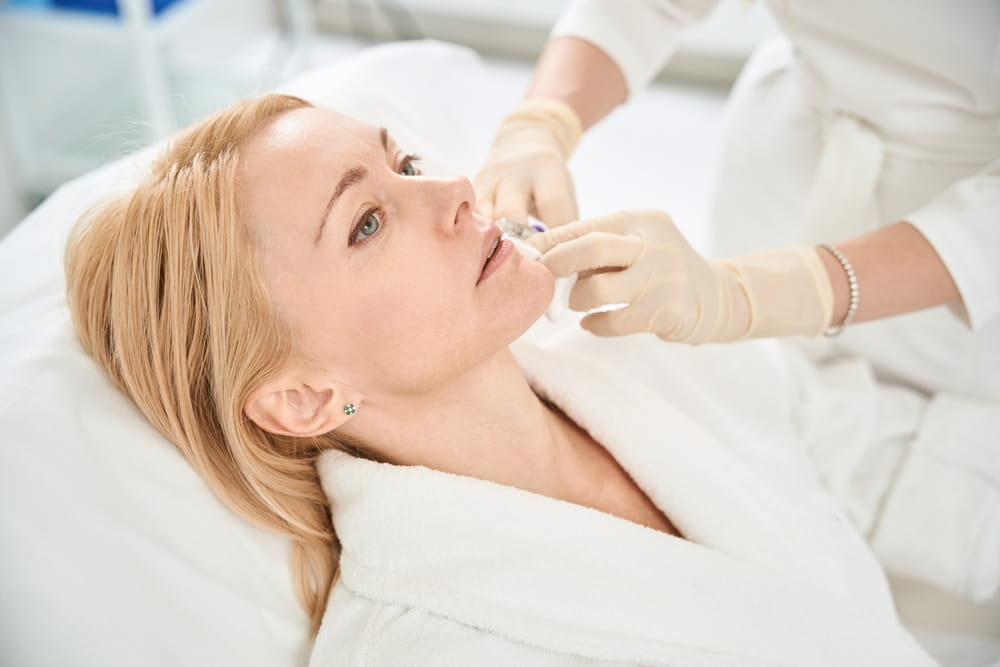 Female client attending procedure of contouring injection