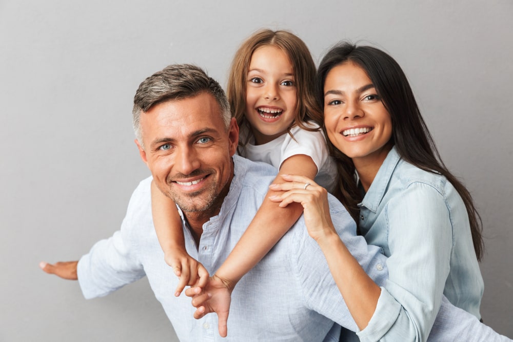 happy family father, mother, little daughter having fun together