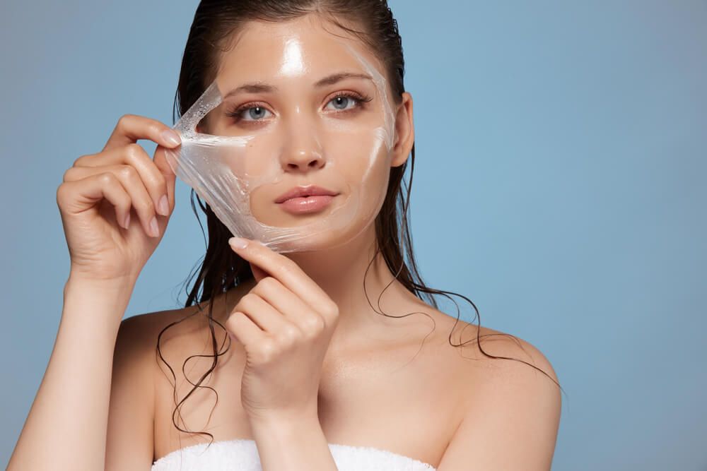 woman removing moisturizing mask