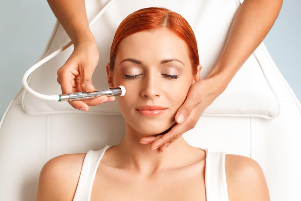 woman with closed eyes getting microdermabrasion