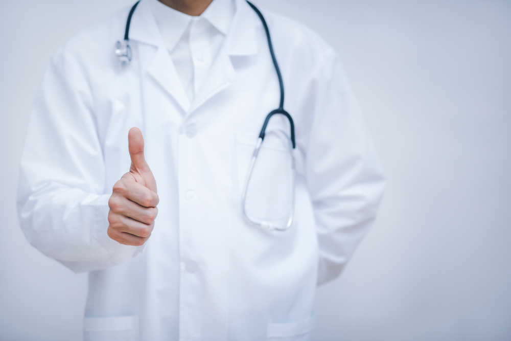 Doctor,Showing,Thumbs,Up,For,Best,Health,And,Insurance,Package