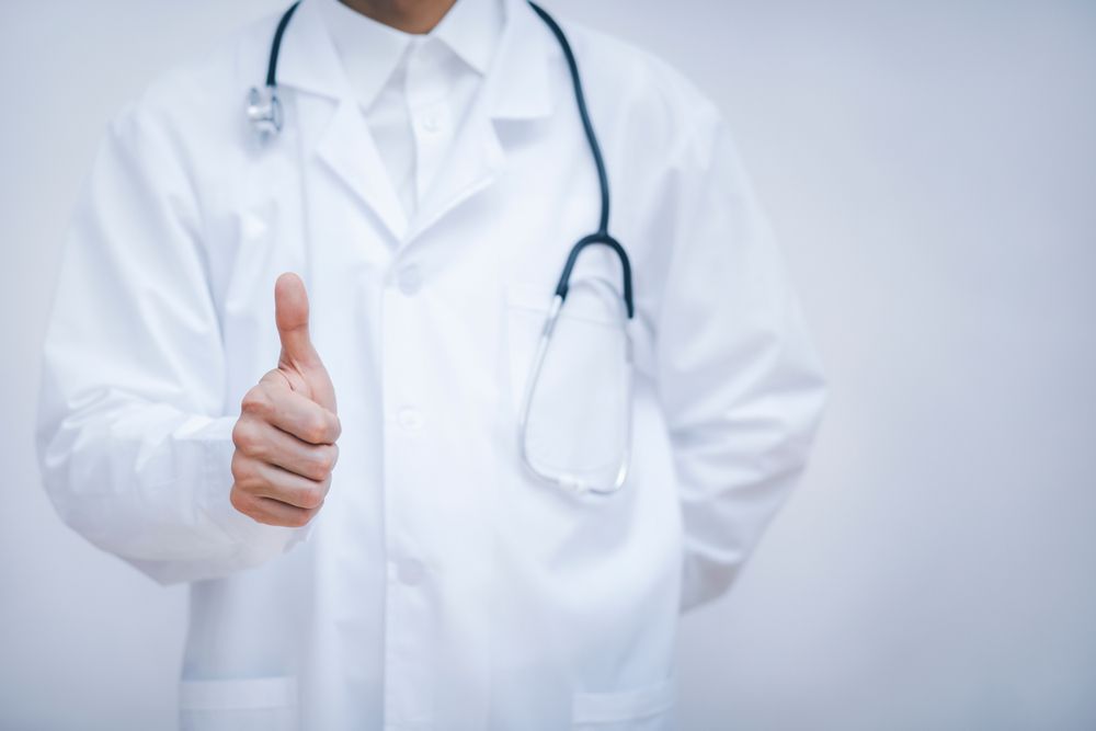 Doctor,Showing,Thumbs,Up,For,Best,Health,And,Insurance,Package
