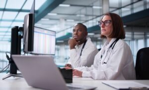 Medical Codes Training Presentation: Doctor And Team In Hospital Setting.