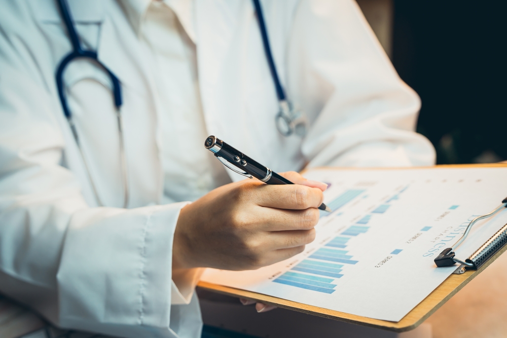 Medical concept. Medical Professional Analyzing Health Data on Clipboard in Clinical Environment.