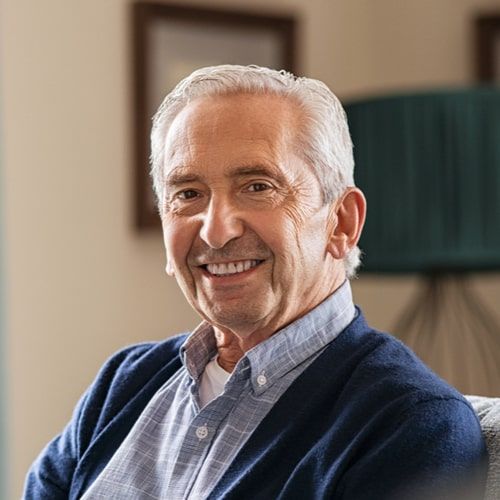 Portrait of happy senior man smiling at home