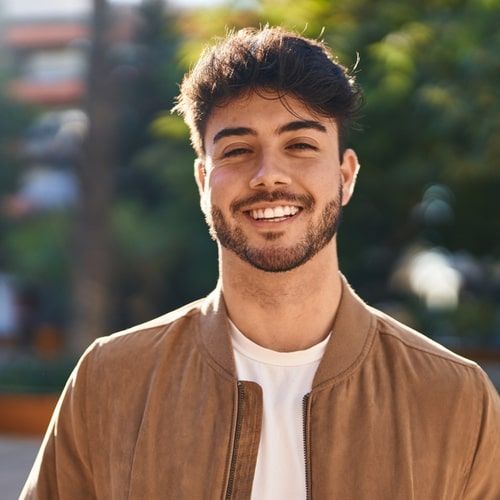 Young man smiling confident standing at park