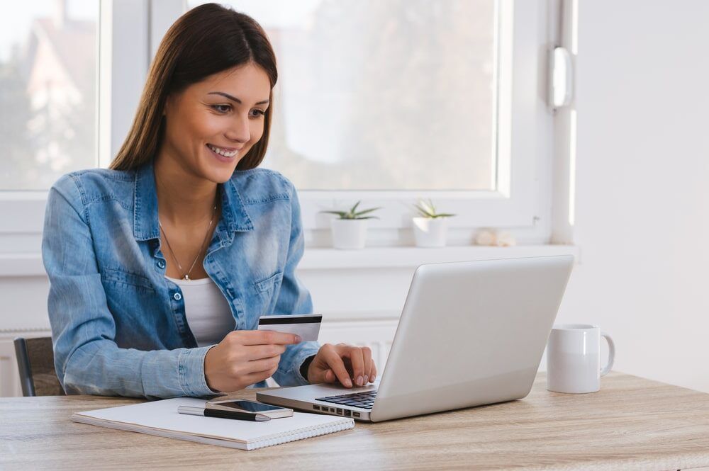 women holding a credit card and purchasing online