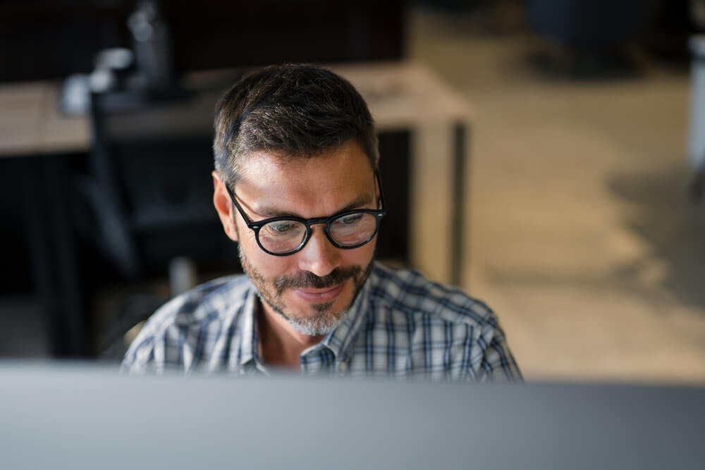 Close Up Young Man in Fashion Glasses Eye Looking Monitor