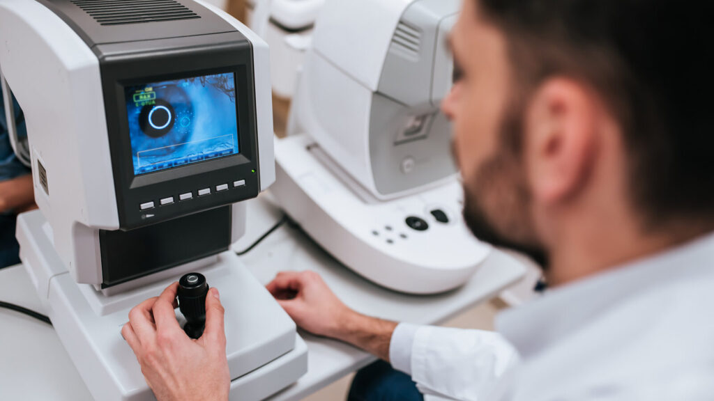 technician taking measurements for orthokeratology also known as ortho-k