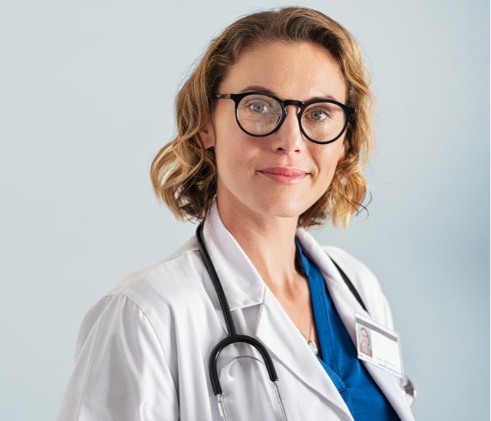 Portrait of happy mid adult smiling doctor looking at camera