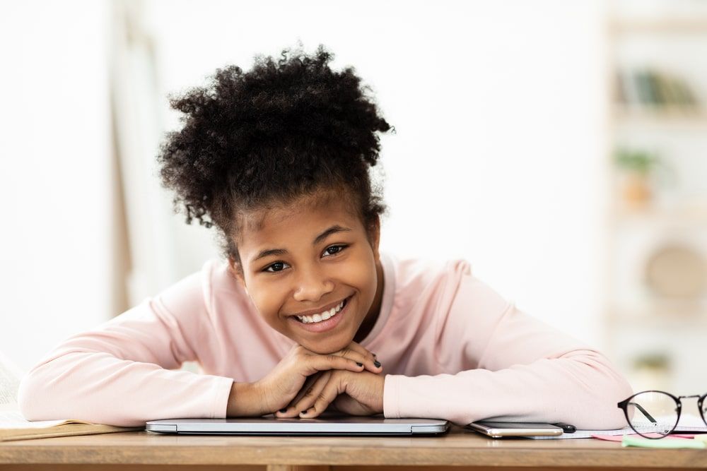Cheerful Black Teen Girl Smiling To Camera
