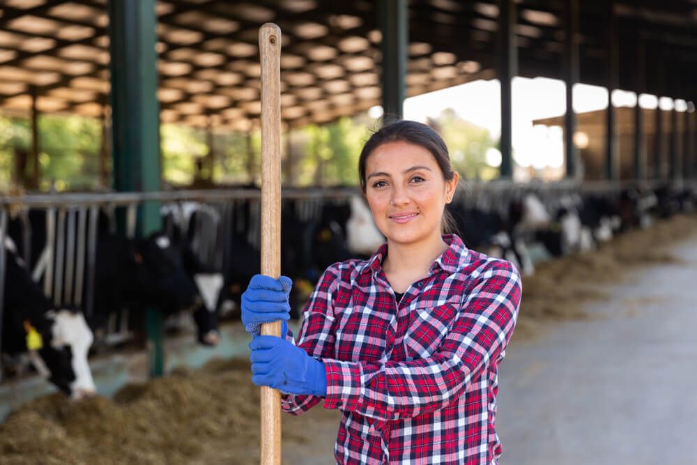 Female farmer posing in cowshed