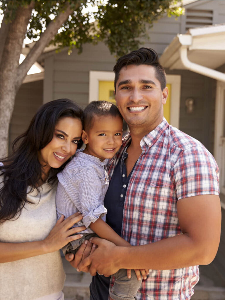 Family Standing Outside Home